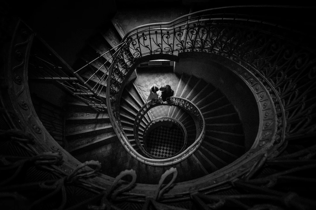 a couple on a spiral staircase